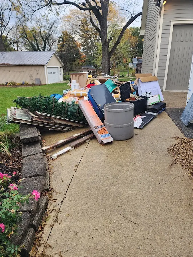 Dumpster being loaded with debris for Estate Cleanout Dumpster Rental in Hialeah